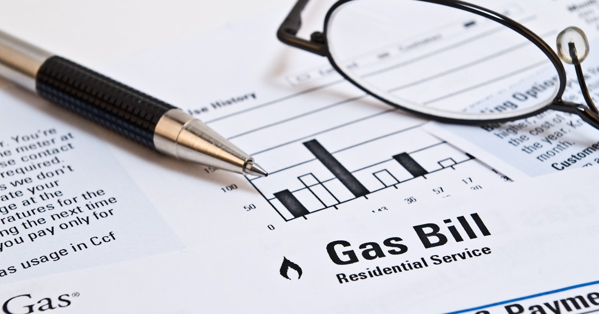 Glasses and pen on top of a gas bill